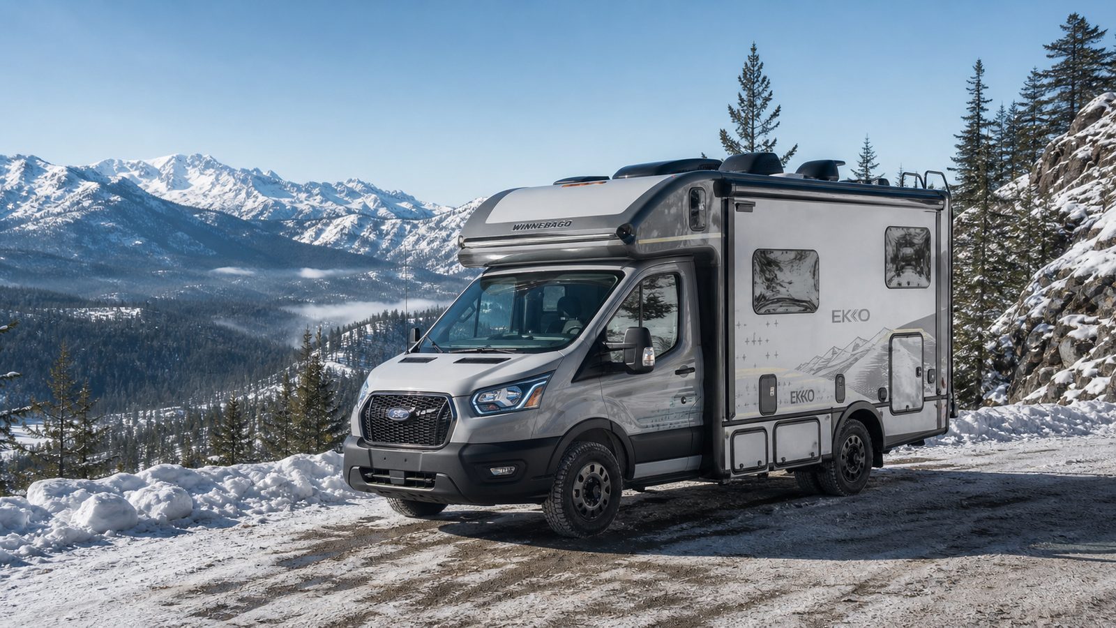 Winnebago EKKO style compact adventure RV parked near a snowy mountain overlook